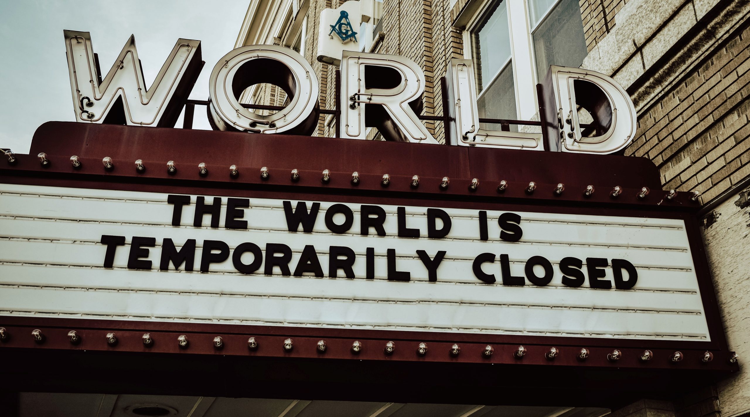 Theatre sign "The World Is Closed" | Photo by Edwin Hooper on Unsplash